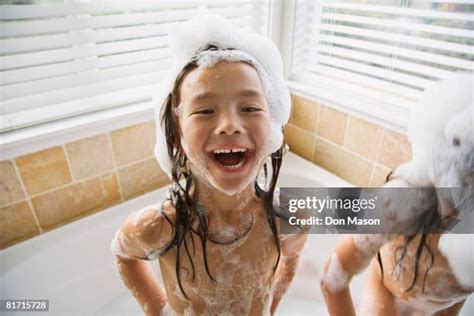 cute young girl lovers bathe together under a shower in a dark。